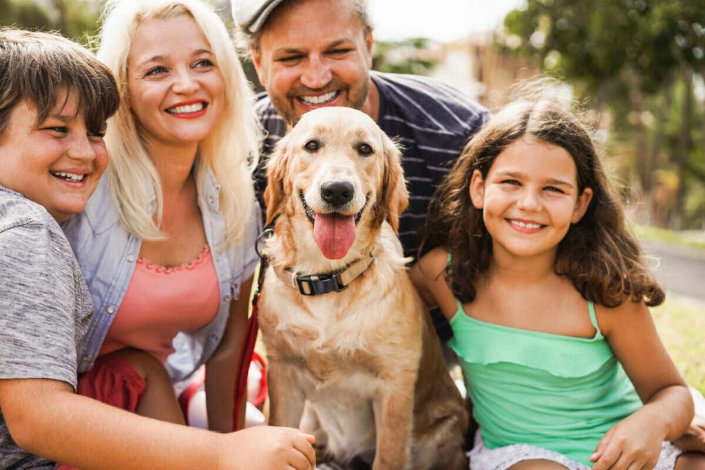 happy and smiling mom, dad, son, daughter and dog having fun