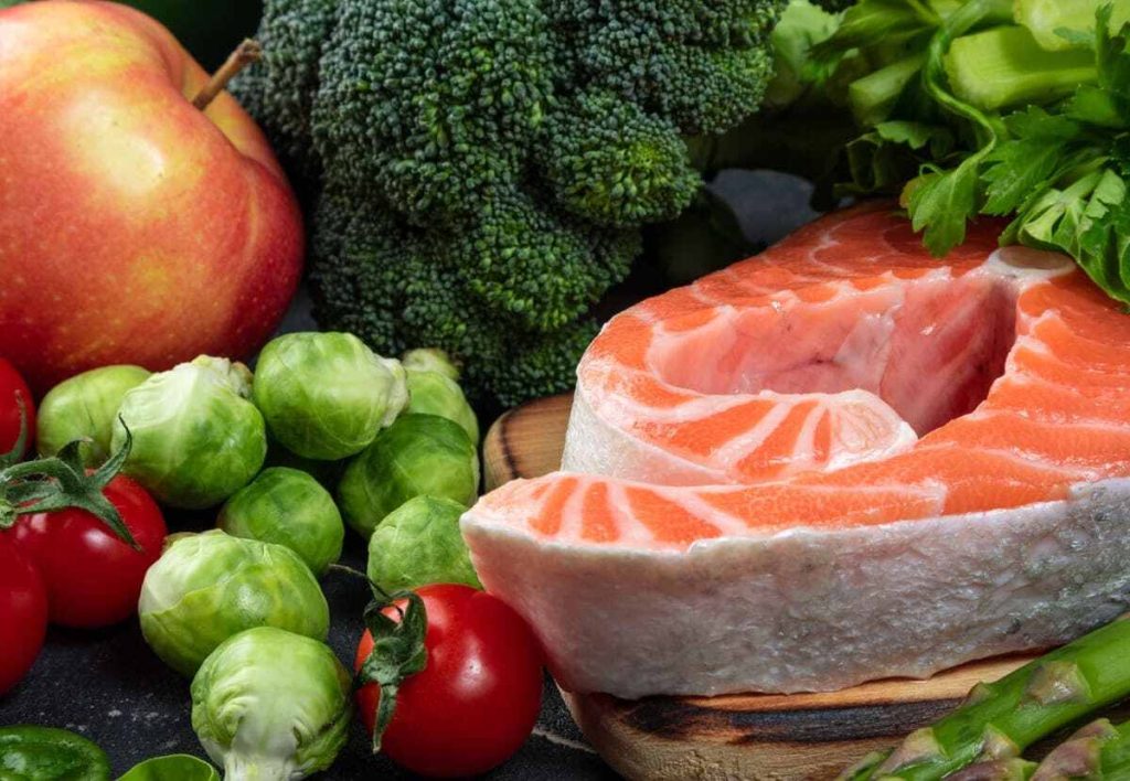 fish and healthy vegetables on the kitchen table